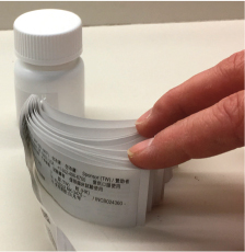 dozens of labels on vial
