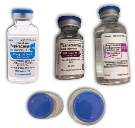 Figure 1. While label colors and vial sizes are different, the caps on ropivacaine, bupivacaine, and tranexamic acid vials may have the same blue color and could lead staff to select a vial based on cap color, without reading the label, especially if the vials are stored upright with only the caps showing. 