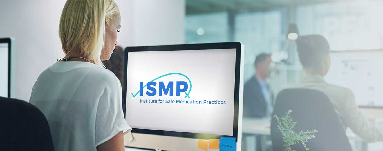 Woman sitting and looking at a computer screen with an ISMP logo