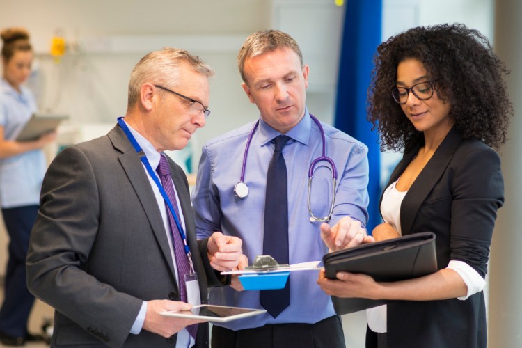 healthcare professionals looking at a document